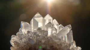 Clear quartz cluster in sunlight showing natural rainbow prisms – clear quartz meaning and benefits healing crystal